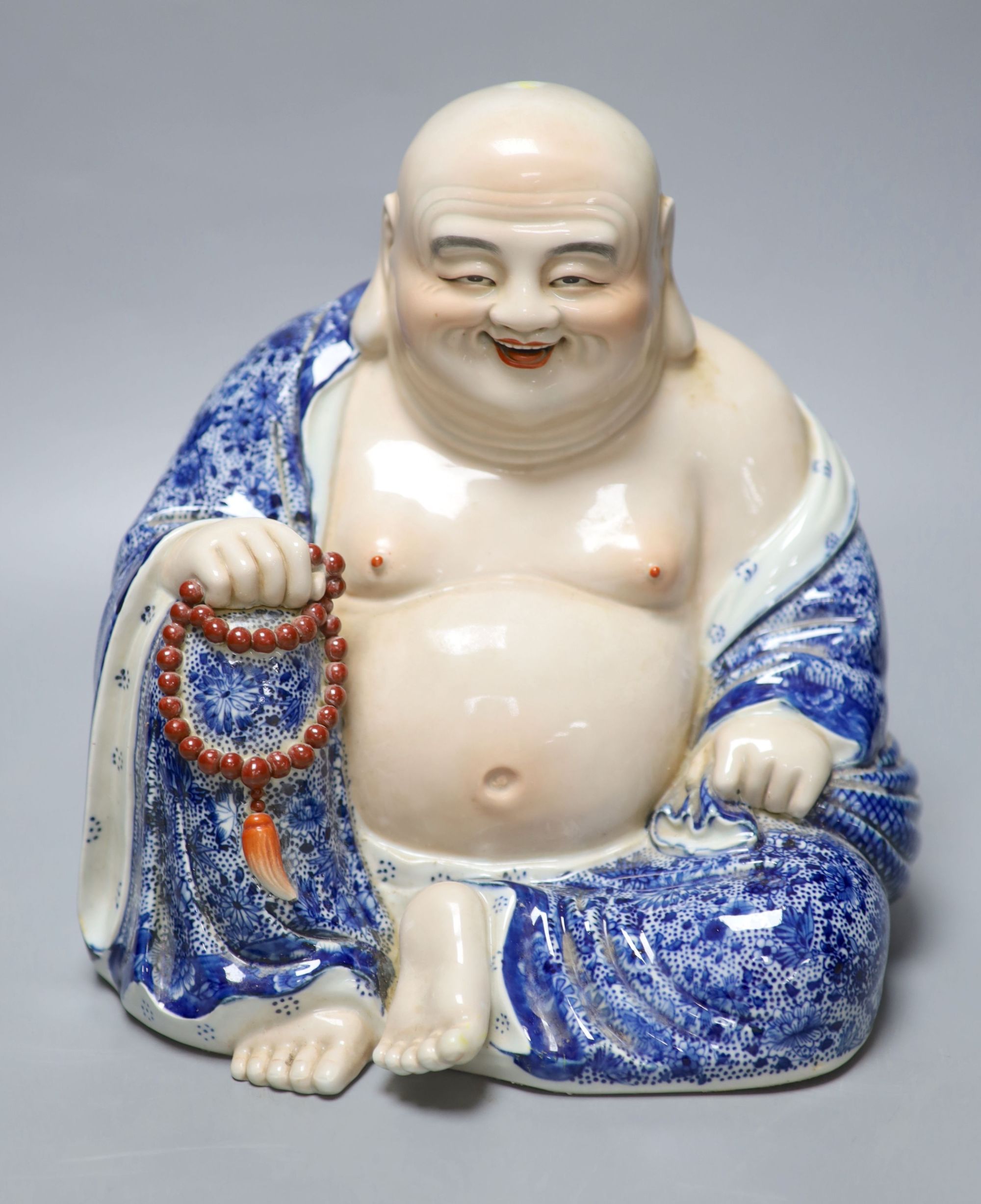 A Chinese porcelain figure of Budai, height 26cm